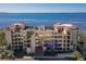 Beautiful condo building with balconies overlooking scenic water views and lush landscaping at 6460 Mourning Dove Dr # 204, Bradenton, FL 34210