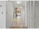Bright hallway featuring tile floors, white doors and a view to the outside at 6460 Mourning Dove Dr # 204, Bradenton, FL 34210