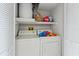 Laundry room with washer, dryer, and storage shelves at 6460 Mourning Dove Dr # 204, Bradenton, FL 34210
