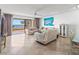 Bright living room with tile floors, ceiling fan, balcony access and water view at 6460 Mourning Dove Dr # 204, Bradenton, FL 34210