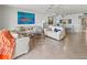 Open-concept living room featuring comfortable seating, tile floors, and natural light at 6460 Mourning Dove Dr # 204, Bradenton, FL 34210