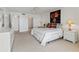 Cozy main bedroom with white comforter, accent painting, and ensuite access at 6460 Mourning Dove Dr # 204, Bradenton, FL 34210