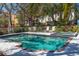 Relaxing pool area features comfortable loungers and lush landscaping at 6460 Mourning Dove Dr # 204, Bradenton, FL 34210