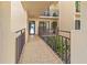 Exterior walkway with railing providing entry access to condo at 6460 Mourning Dove Dr # 204, Bradenton, FL 34210