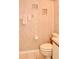Modest bathroom featuring a toilet and pink floral wallpaper at 6505 Stone River Rd # 306, Bradenton, FL 34203