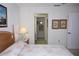 Cozy bedroom featuring an ensuite bathroom, coastal artwork, and ample closet space at 6505 Stone River Rd # 306, Bradenton, FL 34203