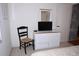 Bedroom area with dresser, television, and a decorative chair at 6505 Stone River Rd # 306, Bradenton, FL 34203
