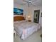 Comfortable bedroom boasts a ceiling fan, neutral tones, and access to an ensuite bathroom at 6505 Stone River Rd # 306, Bradenton, FL 34203