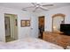 Bedroom with ceiling fan and ensuite bathroom access features a dresser and stylish mirror at 6505 Stone River Rd # 306, Bradenton, FL 34203