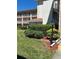 Exterior view of a condo building with mature landscaping at 6505 Stone River Rd # 306, Bradenton, FL 34203