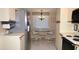 Functional kitchen with stainless steel refrigerator, white cabinets, and dining area with chairs at 6505 Stone River Rd # 306, Bradenton, FL 34203
