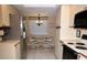 Functional kitchen with stainless steel refrigerator, white cabinets, and dining area with chairs at 6505 Stone River Rd # 306, Bradenton, FL 34203