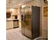 Stainless steel refrigerator in a kitchen with neutral colors and tile flooring at 6505 Stone River Rd # 306, Bradenton, FL 34203