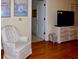 Comfortable living room with a white armchair, TV, and doorway to another room at 6505 Stone River Rd # 306, Bradenton, FL 34203