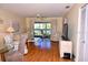 Bright living room with a striped sofa, TV, and sliding door to a balcony at 6505 Stone River Rd # 306, Bradenton, FL 34203