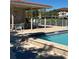 Community pool with covered patio area and plenty of seating for residents to relax and socialize at 6505 Stone River Rd # 306, Bradenton, FL 34203