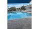 Outdoor pool with clear blue water and plenty of lounge chairs at 6505 Stone River Rd # 306, Bradenton, FL 34203