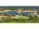Stunning aerial shot of golf course with multiple ponds, lush trees and well-manicured greens at 6637 Taeda Dr, Sarasota, FL 34241