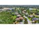 Aerial view of a neighborhood with mature trees, lakes, and manicured lawns at 6637 Taeda Dr, Sarasota, FL 34241