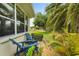 View of backyard patio seating with manicured lawn and lush landscaping at 6637 Taeda Dr, Sarasota, FL 34241