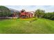 Spacious backyard with a vibrant green lawn and a large red playset for entertainment at 6637 Taeda Dr, Sarasota, FL 34241