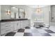 Modern bathroom boasting double vanity, soaking tub under glass block window, and a separate tiled shower with dual showerheads at 6637 Taeda Dr, Sarasota, FL 34241