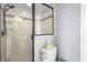 Well-lit bathroom featuring a tiled shower with a glass door and sleek fixtures at 6637 Taeda Dr, Sarasota, FL 34241