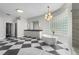 Spacious primary bathroom with dual vanity, soaking tub, walk-in shower, and checkerboard floor at 6637 Taeda Dr, Sarasota, FL 34241