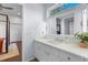 Bright bathroom with modern vanity, white marble countertop, mirror, and access to bedroom at 6637 Taeda Dr, Sarasota, FL 34241