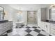 Bathroom with modern tub, walk-in shower, marble floor and dual vanities at 6637 Taeda Dr, Sarasota, FL 34241