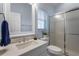 Bright bathroom with a white vanity, a walk-in shower with glass doors, and window with natural light at 6637 Taeda Dr, Sarasota, FL 34241