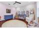 Bedroom featuring floral wall decor, grey crib, dresser, and plush seating at 6637 Taeda Dr, Sarasota, FL 34241