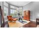Bedroom showcases a chandelier, abundant windows, a cozy chair, and wood flooring at 6637 Taeda Dr, Sarasota, FL 34241