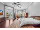 This bedroom features a neutral color palette, abundant windows, and access to a private balcony at 6637 Taeda Dr, Sarasota, FL 34241