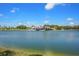Beautiful golf course clubhouse on the water, parking lot, and landscaping on a sunny day at 6637 Taeda Dr, Sarasota, FL 34241