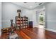 Bright home gym featuring workout machine, hardwood floors and bookshelf, open to patio at 6637 Taeda Dr, Sarasota, FL 34241