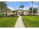 Well-manicured lawn leads to an inviting single-story home with barrel tile roof at 6637 Taeda Dr, Sarasota, FL 34241