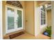 Close-up of a welcoming front door with a welcome mat, sidelight window, and ADT security sign at 6637 Taeda Dr, Sarasota, FL 34241