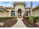 Inviting front entrance with manicured landscaping, arched windows, and a stylish entryway at 6637 Taeda Dr, Sarasota, FL 34241