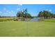 Manicured golf green with flag and scenic view of water and landscape at 6637 Taeda Dr, Sarasota, FL 34241