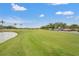 Picture of the golf course featuring the fairway, pond, and adjacent cart parking at 6637 Taeda Dr, Sarasota, FL 34241