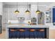Modern kitchen with blue island, white countertops, pendant lights and stainless appliances at 6637 Taeda Dr, Sarasota, FL 34241