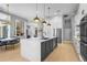 Spacious kitchen featuring a large island with modern pendant lighting, stainless appliances, and lots of storage at 6637 Taeda Dr, Sarasota, FL 34241