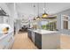 The spacious open kitchen has a large island, granite counters, stainless steel appliances, and abundant storage at 6637 Taeda Dr, Sarasota, FL 34241