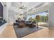 Spacious living room with tile floor, large sectional sofa, tray ceiling and sliding glass door to the patio at 6637 Taeda Dr, Sarasota, FL 34241