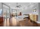 Large main bedroom with wood floor, ceiling fan, sitting area, and walkout to the pool at 6637 Taeda Dr, Sarasota, FL 34241