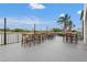 Outdoor patio with lakeside views and string lights for ambiance at 6637 Taeda Dr, Sarasota, FL 34241