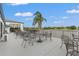 Outdoor seating area with tables and chairs on a patio overlooking the water at 6637 Taeda Dr, Sarasota, FL 34241