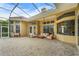 Spacious screened patio with outdoor furniture, overlooking the lush backyard, ideal for relaxation at 6637 Taeda Dr, Sarasota, FL 34241