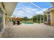 Screened-in pool area with lounge chairs, a play structure and patio space, perfect for outdoor living at 6637 Taeda Dr, Sarasota, FL 34241